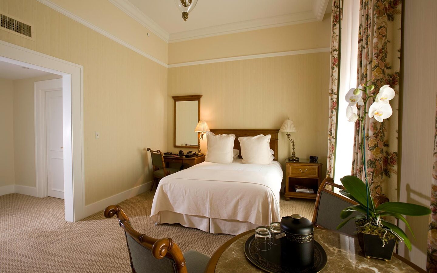 accessible guest room with wider door frames, a queen bed, and more space
